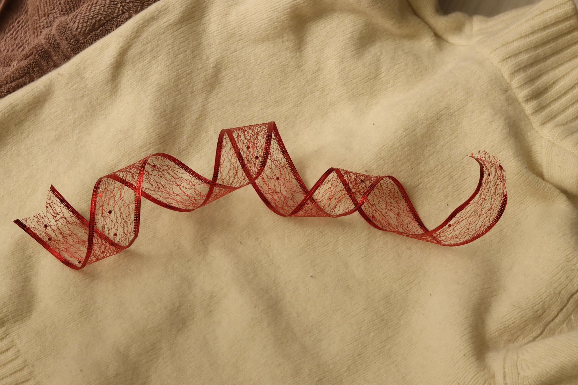 Close-up of hand embroidery on linen with natural threads